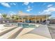 Backyard features a sparkling pool, spa, covered seating, and privacy fence at 516 45Th Street W Ct, Palmetto, FL 34221