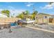 Backyard view of a white boat on a trailer next to a shed and wooden fence at 516 45Th Street W Ct, Palmetto, FL 34221