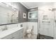 Updated bathroom features gray vanity with a white countertop and glass walk-in shower at 516 45Th Street W Ct, Palmetto, FL 34221