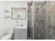 Modern bathroom with stylish marble-tiled shower, white shiplap wall and wood-framed mirror at 516 45Th Street W Ct, Palmetto, FL 34221