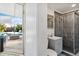 Bright bathroom with grey vanity, marble-tiled shower, and access to an outdoor pool area at 516 45Th Street W Ct, Palmetto, FL 34221