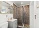 Bathroom features a sleek gray vanity and a contemporary shower with marble-like tiles at 516 45Th Street W Ct, Palmetto, FL 34221