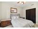 This is a neutrally decorated bedroom with a ceiling fan and wood-look flooring at 516 45Th Street W Ct, Palmetto, FL 34221