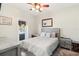 Cozy bedroom features neutral decor, a ceiling fan, and sliding door leading to the outdoors at 516 45Th Street W Ct, Palmetto, FL 34221
