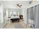 Bright bedroom features a ceiling fan, wood-look floors, and a large window for natural light at 516 45Th Street W Ct, Palmetto, FL 34221