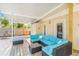 View of a covered patio featuring a blue sectional sofa and glass table at 516 45Th Street W Ct, Palmetto, FL 34221