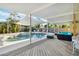 Inviting backyard oasis features a sparkling pool, spa, and shaded seating area at 516 45Th Street W Ct, Palmetto, FL 34221