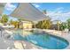 Outdoor swimming pool with a sunshade and spa in the backyard at 516 45Th Street W Ct, Palmetto, FL 34221