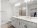Bright, modern bathroom with double sinks, white cabinetry, and a walk-in shower at 5317 Patano Loop, Palmetto, FL 34221