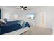 Bright bedroom featuring a ceiling fan, television, and a large window for natural light, offering a relaxing space at 5317 Patano Loop, Palmetto, FL 34221