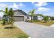 Beautiful home with a stone facade, manicured lawn, and paved driveway at 5317 Patano Loop, Palmetto, FL 34221