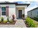 Inviting front entry with a beautifully landscaped walkway and decorative plants leading to a stylish front door at 5317 Patano Loop, Palmetto, FL 34221