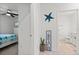 Hallway displaying a decorative starfish and a glimpse into an adjacent bedroom, adding coastal charm at 5317 Patano Loop, Palmetto, FL 34221