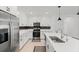 Bright kitchen boasts quartz countertops, stainless steel appliances, and ample storage space in white cabinets at 5317 Patano Loop, Palmetto, FL 34221