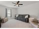 Comfortable living room with plush seating, soft carpeting, and a large window, creating a cozy atmosphere at 5317 Patano Loop, Palmetto, FL 34221