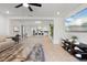 Open-concept living area with tile floors, modern furnishings, and seamless flow to the kitchen at 5317 Patano Loop, Palmetto, FL 34221
