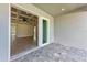 Covered back porch with brick pavers and a view to the interior through sliding glass doors at 5322 Syracuse Rd, Venice, FL 34293