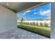 Covered back porch with brick pavers overlooking a lush, fenced backyard with new landscaping at 5322 Syracuse Rd, Venice, FL 34293