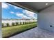 Covered back porch with brick pavers overlooking a lush, fenced backyard with new landscaping at 5322 Syracuse Rd, Venice, FL 34293