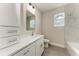 Bright bathroom featuring a modern vanity, large mirror, and sleek marble-look shower at 5322 Syracuse Rd, Venice, FL 34293
