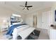 Cozy bedroom featuring a ceiling fan, accent furniture, and serene decor for a relaxing ambiance at 5322 Syracuse Rd, Venice, FL 34293