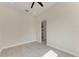 This bedroom features a ceiling fan and a view into an adjacent room at 5322 Syracuse Rd, Venice, FL 34293