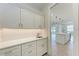 Bright butler's pantry with white cabinets, countertop, and a doorway to the kitchen at 5322 Syracuse Rd, Venice, FL 34293