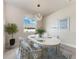 Elegant dining room features a modern chandelier, a decorative table setting, and bright natural light at 5322 Syracuse Rd, Venice, FL 34293