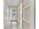 Bright entryway featuring a modern front door, closet, and stylish sliding barn door enhancing the interior appeal at 5322 Syracuse Rd, Venice, FL 34293