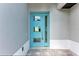 Modern turquoise front door with glass panels offering a bright and welcoming entrance to the home at 5322 Syracuse Rd, Venice, FL 34293