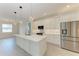 Modern kitchen with a kitchen island, stainless steel appliances, and sleek pendant lighting at 5322 Syracuse Rd, Venice, FL 34293