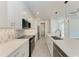 Modern kitchen features sleek white cabinets, stainless steel appliances, elegant pendant lighting, and a stylish backsplash at 5322 Syracuse Rd, Venice, FL 34293
