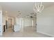 Open-concept living space with a modern kitchen, living and dining area with tile flooring and modern lighting at 5322 Syracuse Rd, Venice, FL 34293