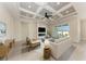 Inviting living room featuring a coffered ceiling, modern fireplace, and sliding glass doors to the backyard at 5322 Syracuse Rd, Venice, FL 34293