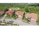 Aerial view showcasing the home's desirable location near the golf course with lush landscaping at 5412 Royal Poinciana Way, North Port, FL 34291