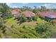 A backyard with a screened lanai, a private pool, lush landscaping, and mature trees at 5412 Royal Poinciana Way, North Port, FL 34291