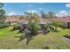A backyard with a screened lanai, a private pool, manicured landscaping, and mature trees at 5412 Royal Poinciana Way, North Port, FL 34291