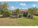 Spacious backyard with screened-in pool area and tropical landscaping at 5412 Royal Poinciana Way, North Port, FL 34291