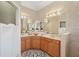 Elegant bathroom featuring dual sinks, stylish lighting, and a spacious layout at 5412 Royal Poinciana Way, North Port, FL 34291