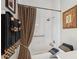 Well-lit bathroom featuring a shower over the tub and matching accent towels and shower curtain at 5412 Royal Poinciana Way, North Port, FL 34291