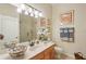 Bathroom with granite countertops, decorative bowl, and a glass-enclosed shower at 5412 Royal Poinciana Way, North Port, FL 34291