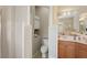 Bright bathroom with a white toilet, cabinet, and a vanity with a marble countertop at 5412 Royal Poinciana Way, North Port, FL 34291