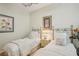 Light and airy bedroom featuring two twin beds with wood flooring and ceiling fan at 5412 Royal Poinciana Way, North Port, FL 34291