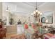 Bright dining area with elegant chandelier and ample space for Gathering gatherings at 5412 Royal Poinciana Way, North Port, FL 34291
