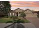 A beautiful single-Gathering home with a well-manicured lawn, professional landscaping, and a three-car garage at 5412 Royal Poinciana Way, North Port, FL 34291