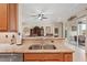Open kitchen with stainless steel sink, granite countertops, and easy access to the living room and outdoor patio at 5412 Royal Poinciana Way, North Port, FL 34291