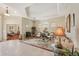 Well-lit living room featuring tile floors, high ceilings, and a cozy seating arrangement at 5412 Royal Poinciana Way, North Port, FL 34291