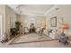 Elegant living room featuring tray ceilings, tile floors, and classic furnishings at 5412 Royal Poinciana Way, North Port, FL 34291