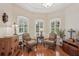 Elegant living room showcasing plantation shutters, hardwood floors, and decorative furnishings at 5412 Royal Poinciana Way, North Port, FL 34291