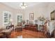 Comfortable living room with rich hardwood floors, plantation shutters, and traditional decor at 5412 Royal Poinciana Way, North Port, FL 34291